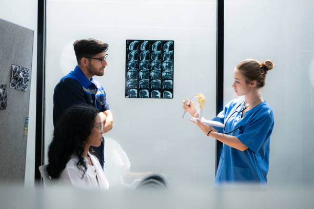 istock Engineers, doctors and physical therapists brainstorm ideas to design a robot with arm and hand organs, To be utilized for additional testing on patients. 2099135788