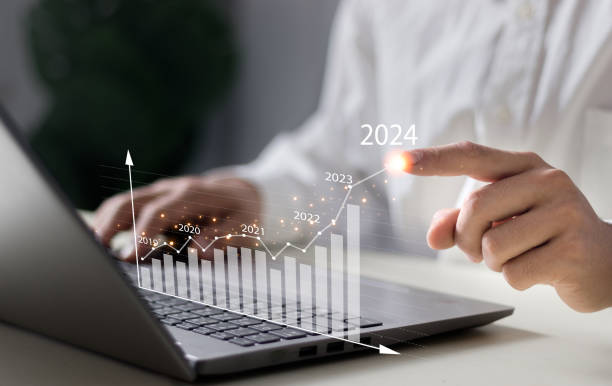 istock Businessman working on digital laptop computer with digital graph chart graphic, positive indicators in 2024, business calculate financial data, Digital marketing, finance, trade stock market concept. 2099149410