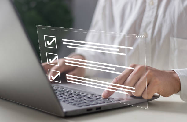 istock Businessman smart checklist and signs electronic on digital documents concept, Businessman use a pen signs on virtual screen documents with laptop on table 2099155501