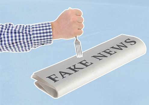 Sifting Through the Hype: Separating Fact from Fake News. Composite Collage in which a man's hand is trying to pierce a newspaper with a fork on which is written large: 