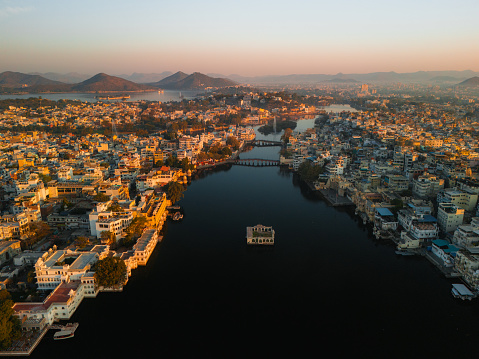 Scenic aerial view of Udaipur Palace  and Pichola lake at sunrise