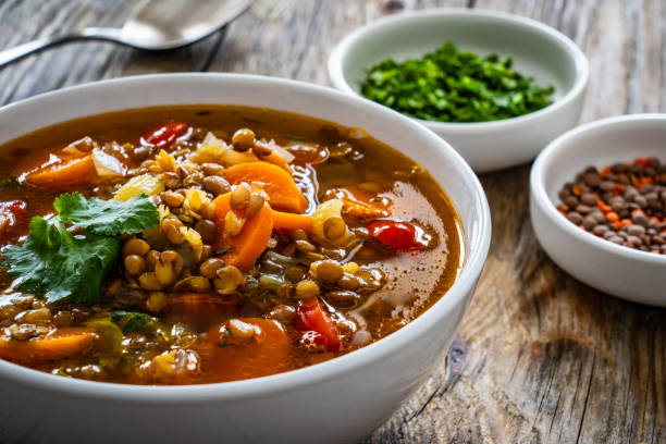 istock Fresh vegetable soup with lentil on wooden table 2099168992