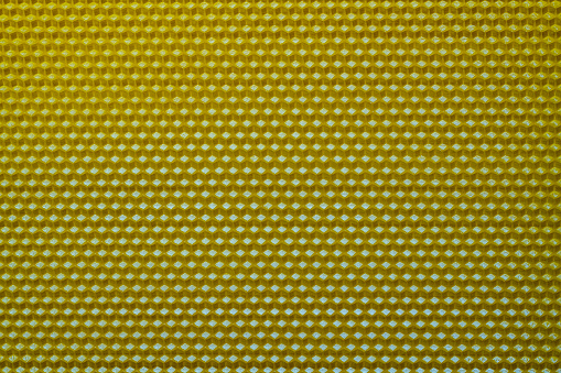 Background texture and pattern of section voshchina of wax honeycomb from a bee hive for filled with honey. Voshchina an artificial basis for the construction of honeycombs, sheet of wax of the cells