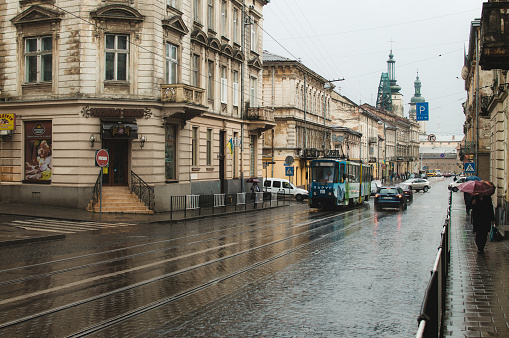 Photo of a Lviv street on a rainy day with passing traffic