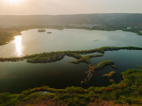 Aerial view of  lake in Jaipur surrounded by forest