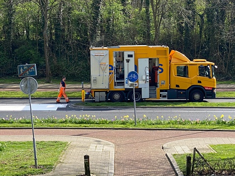 Brunssum, Netherlands - March 20,  2024.  Worker  bussy with painting the road marking on the new asphalt.