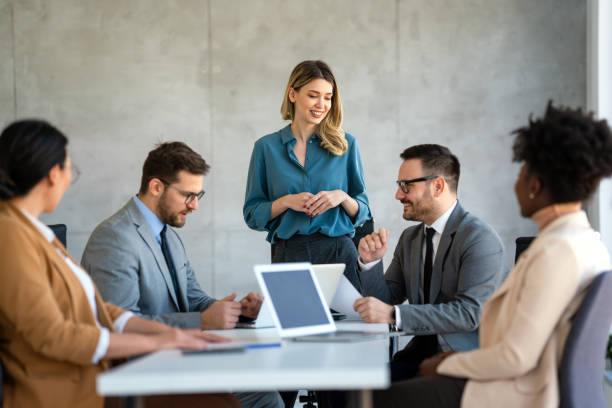 istock Multicultural professional businesspeople working together on research plan in boardroom. 2099201456