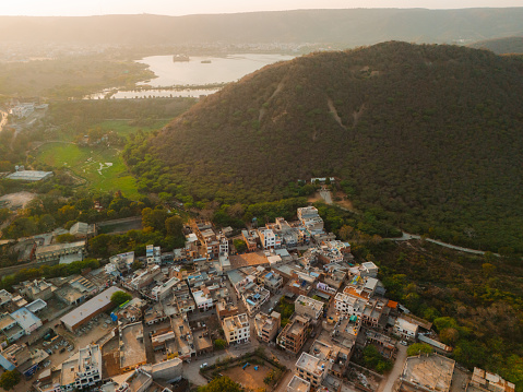 Scenic directly above aeril view of residential neighbourhood in India surrounded by forest