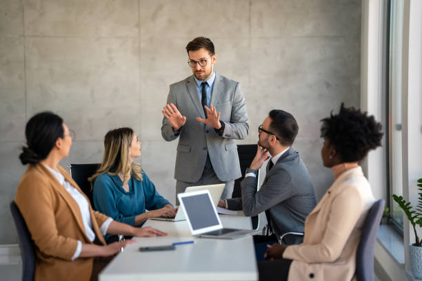 istock Multicultural professional businesspeople working together on research plan in boardroom. 2099220003