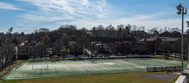 Pittsburgh, Pennsylvania, USA March 5, 2024 The CMU Soccer field on the campus of Carnegie Mellon University with houses behind it on a sunny winter day