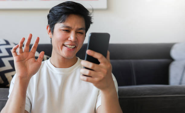 istock close up young middle eastern man holding smartphone and using video call conference application to connect with friends and family for new normal lifestyle and technology VOIP concept 2099234084