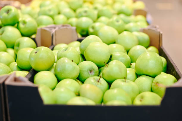 Selling fruit apples in a store. Side view, close-up.
