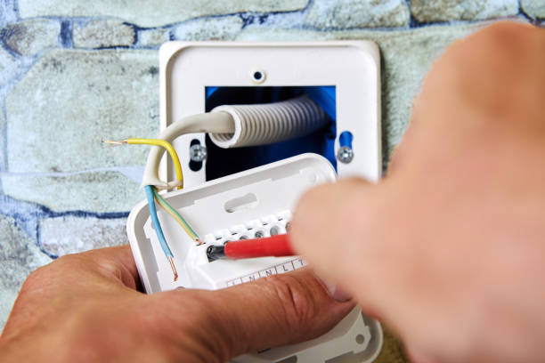 istock Installing wall thermostat for floor heating system, an electrician secures wire to outlet terminal. 2099251675