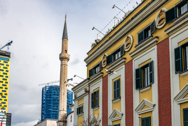 Tirana, Albania. 12 March 2024. Old and new architecture in Tirana with as mosque minaret.