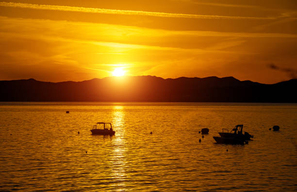 Many boats at sunset in the bay.