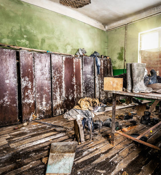 istock Old scattered working clothes in abandoned molded room 2099278102