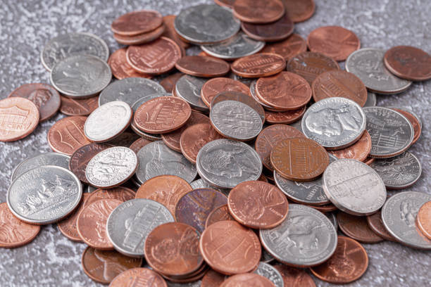 American coins and US dollars on a wooden table