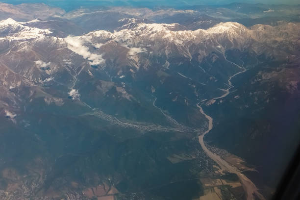 A landscape with mountainous terrain, from snowy peaks and below, where mountain rivers make their way through the crevices of the slopes and rush down to the valley, bringing fertility to the locals.