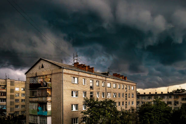 dark stormy tornado clouds over old apartment building