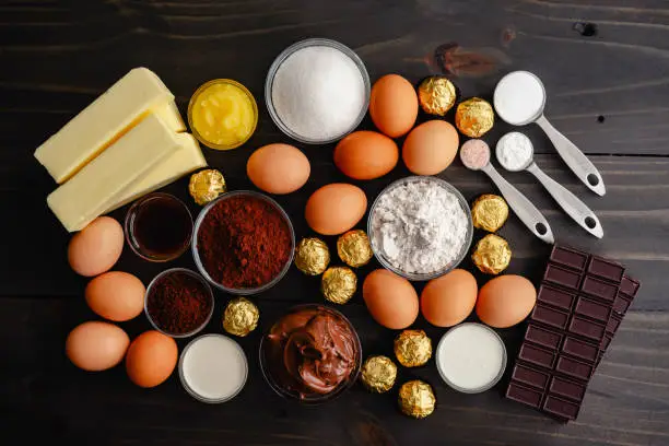 Eggs, cocoa powder, flour and other ingredients for baking a cake for dessert