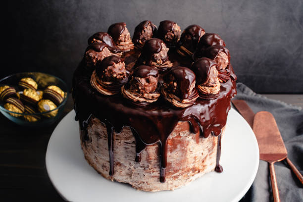 istock Hazelnut Chocolate Cake Topped with Chocolate Ganache and Hazelnut Candies 2099290652