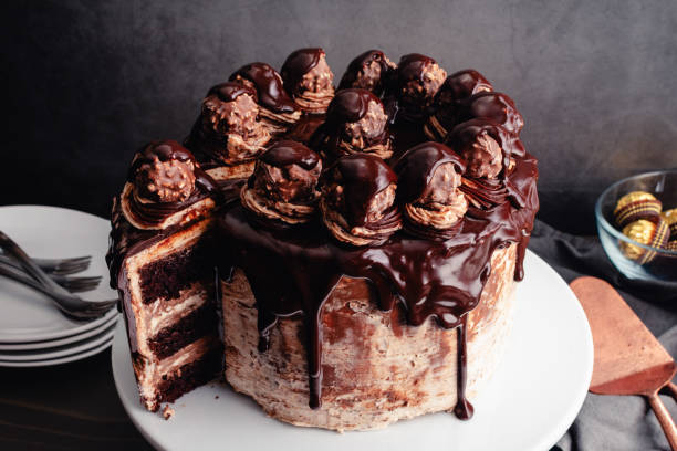 istock Hazelnut Chocolate Cake Topped with Chocolate Ganache and Hazelnut Candies 2099291176