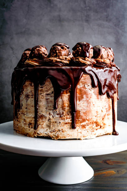 istock Hazelnut Chocolate Cake Topped with Chocolate Ganache and Hazelnut Candies 2099291214