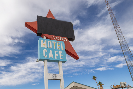 Barstow, California, United States - August 31, 2023: Roy's Cafe Sign in Barstow, California, with a palm tree in the background