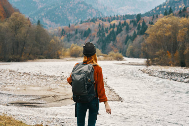 istock woman wearing a hat backpack landscape mountains model gesturing with hands 2099304427