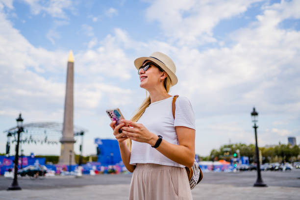 istock Woman using phone on Concorde square in Paris, France 2099304939