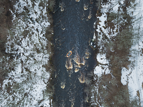 Rubber boat rafting on the Jagala River in winter, drone air photography. High quality photo