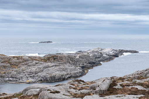 Coastal landscape with rocky beach in Norwegian fjord (in Western Norway) on an afternoon in spring (May).
