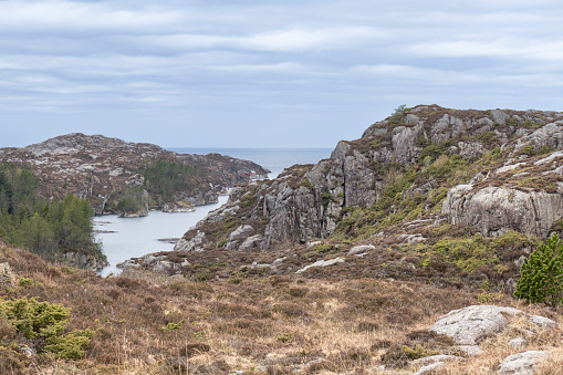 Coastal landscape with rocky beach in Norwegian fjord (in Western Norway) on an afternoon in spring (May).