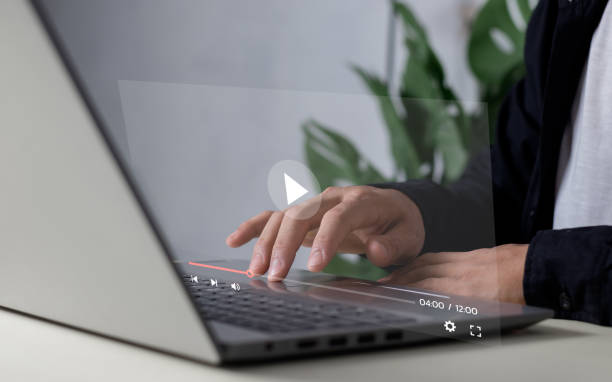 istock Man using laptop for streaming online, watching video on internet, live concert, show or tutorial 2099345244