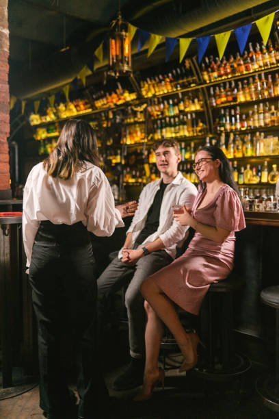 istock Young people smile with spirits drinks at bar counter 2099362479