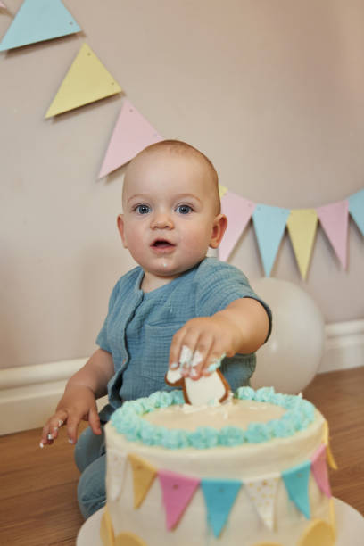 istock Curious little one-year-old exploring his birthday cake, making a mess in the process. 2099371583