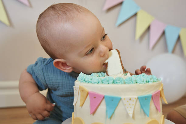 istock The birthday boy looks gleeful while biting into his birthday dessert. 2099376487