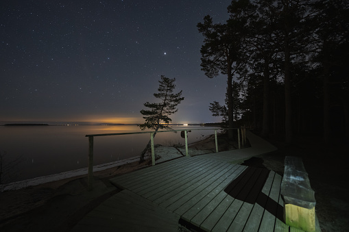 Nature of Estonia, wooden observation deck on the sea in Kaberneeme, night photo with the stars. High quality photo