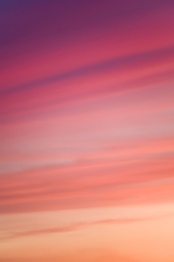 Soft focus on red-hued clouds at sunset, perfect for conveying abstract beauty and mood