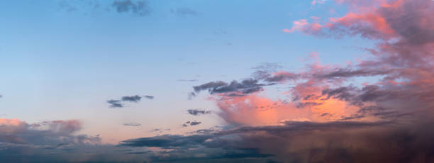 Cloud-streaked sky with a soft glow after thunderstorm, ideal for peaceful themes
