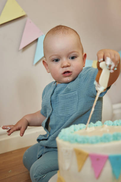 istock Curious little one-year-old exploring his birthday cake, making a mess in the process. 2099402311