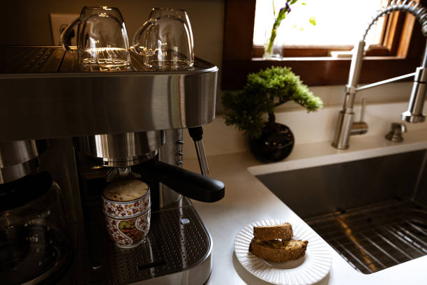 Roasted and raw coffee beans and ground coffee with a full portafilter flat lay on black background