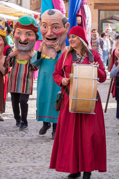 Ivrea, Italy - March 02, 2025: a woman with traditional costume riding an horse during the historical parade at Ivrea Carnival.