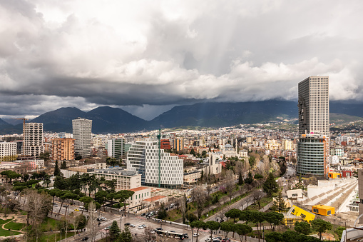 Tirana, Albania. 12 March 2024. Clouds of Tirana city centre with shops and businesses on the roads.