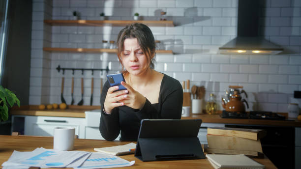 istock Female student video calling makes notes, learning with online teacher, working from home office attending remote conference meeting. 2099456237