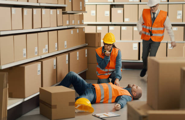 istock Injured man at the warehouse: the workers are calling emergency services 2099461609
