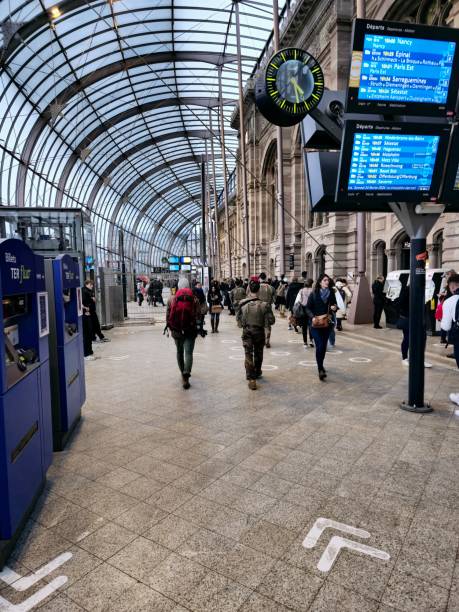 Strasbourg-Ville station is the main railway station in the city of Strasbourg. The image shows people in  the main hall with the huge glass construction realized in 2006/2007.