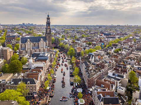 Amsterdam aerial view of Westerkerk church seen from north on Koningsdag Kings day festivities. Birthday of the king. Seen from helicopter.