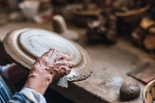 Cup on the pottery wheel in ceramic studio