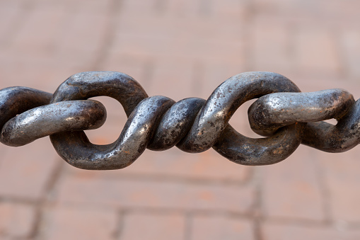 An Iron chain with large metal piece